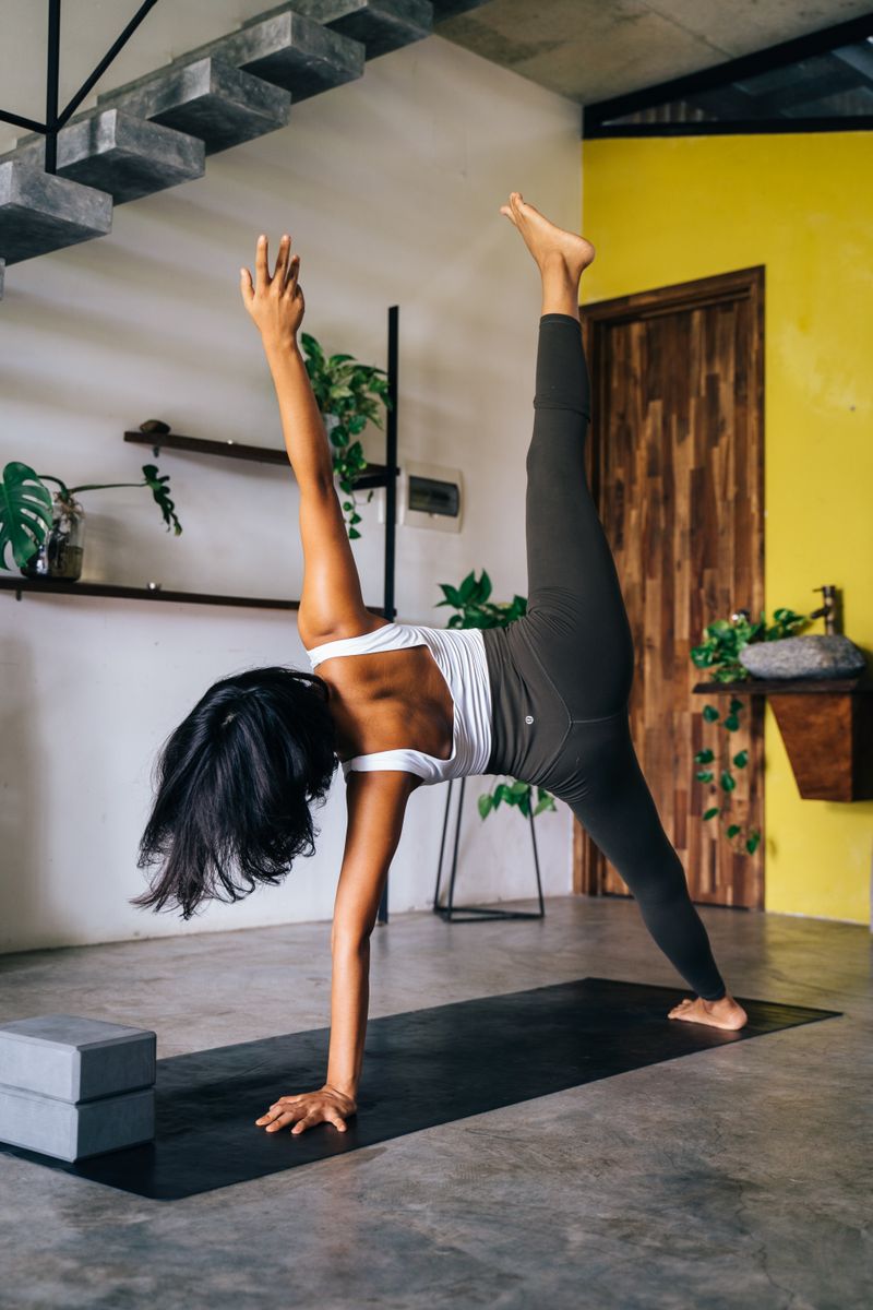Yoga practice on a mat by a window